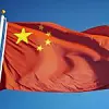 China flag waving against clean blue sky, close up, isolated wit