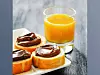 Toasts with chocolate spread and glass of fresh orange juice
