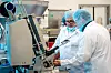 Zwei Mitarbeitende bedienen den PDC 700 von Poly-clip System in einer Produktionshalle.