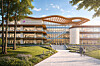 Modernes Gebäude mit Holz- und Glasfassade, Vorplatz, Grünflächen und einem Weg im Vordergrund.